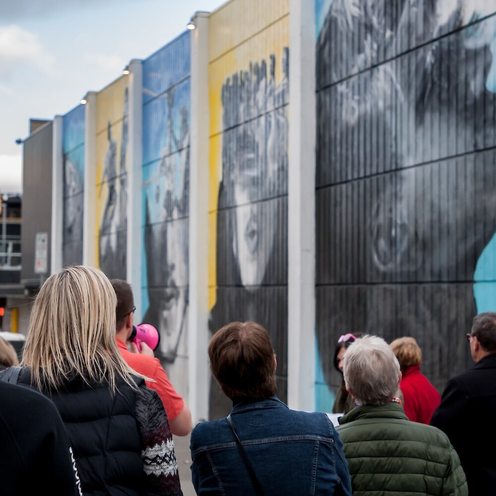 A group admires the an outdoor mural on the Back Alley Art Gallery tour located in downtown Kamloops.