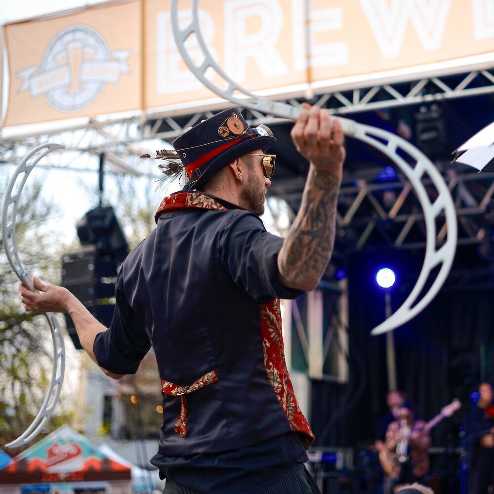 Performer with a band playing in the background at Brewloops Festival in Kamloops, BC.