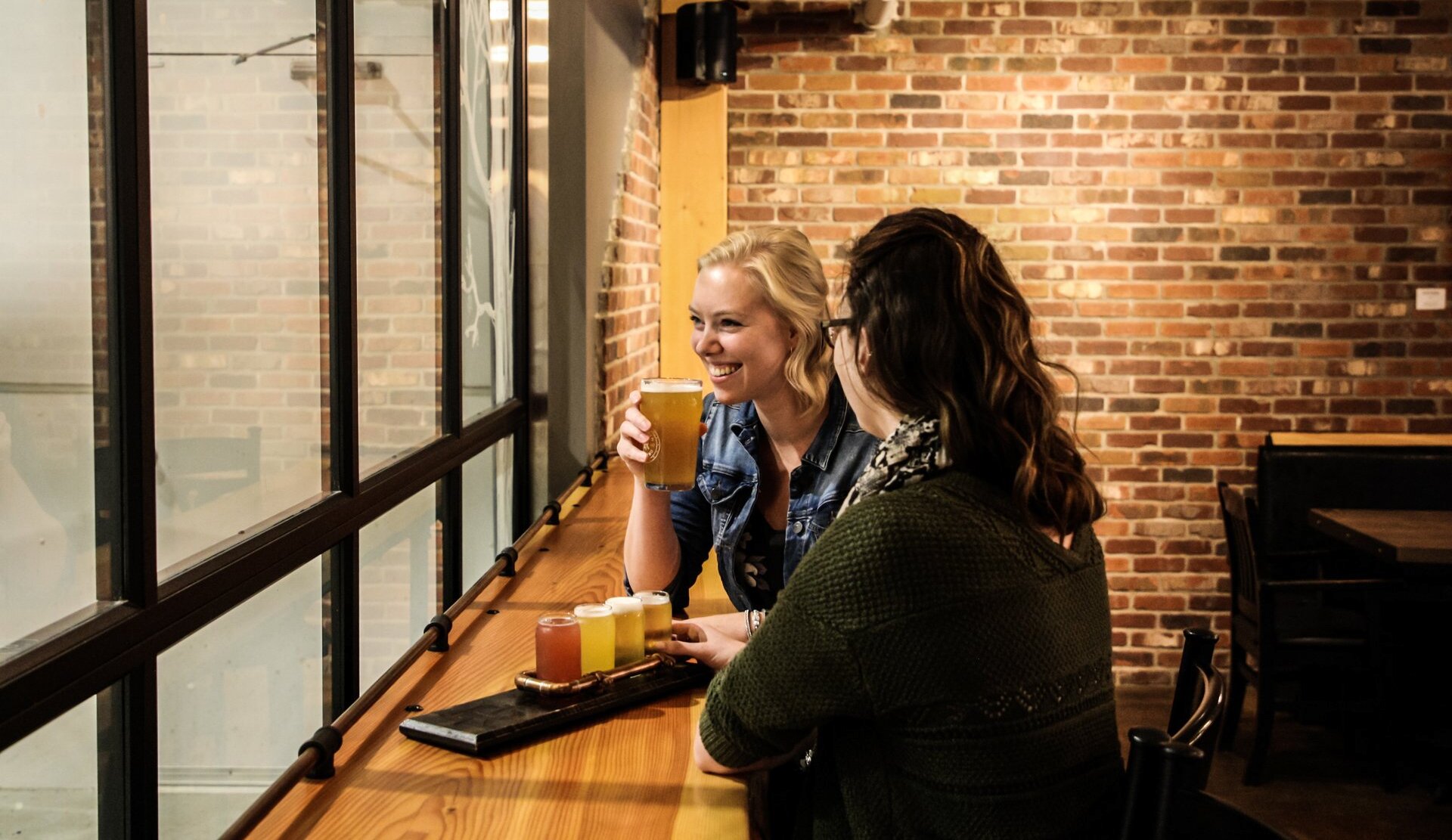 Two women enjoying their craft beer in the Iron Road Brewing taproom in Kamloops, BC.