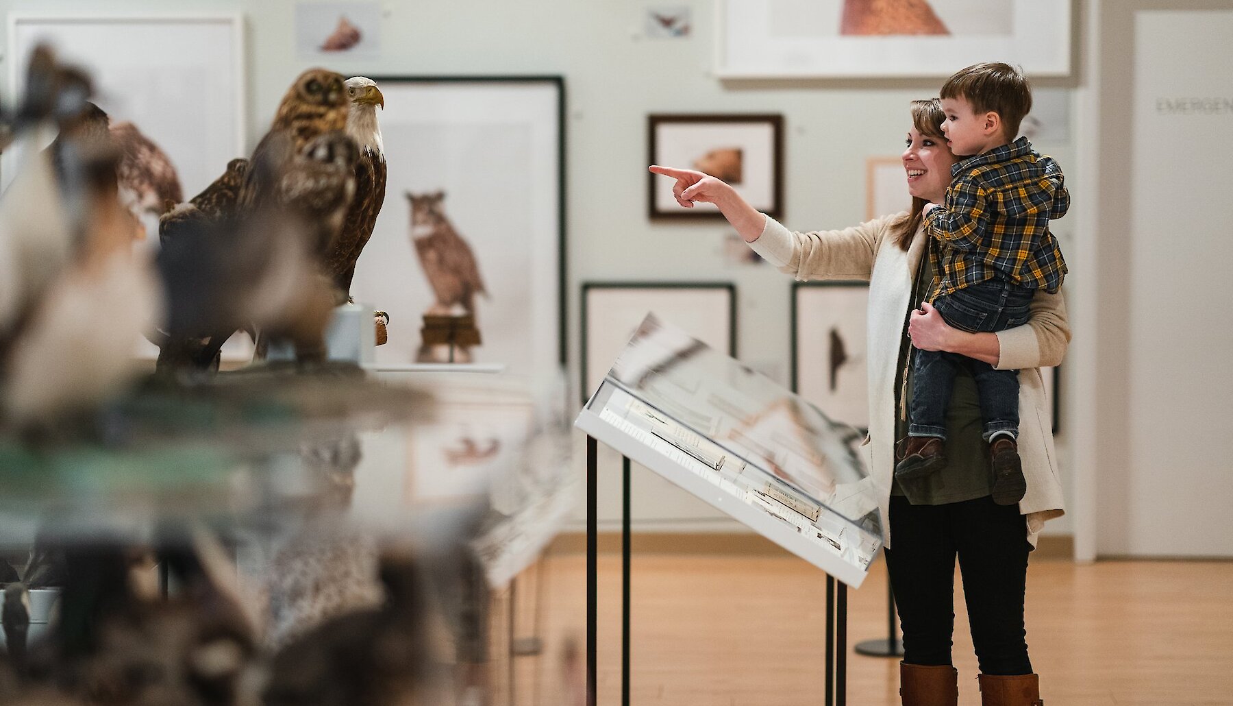 A Mother holding her son admiring the exhibit at Kamloops Museum and Archives located in Kamloops, British Columbia.