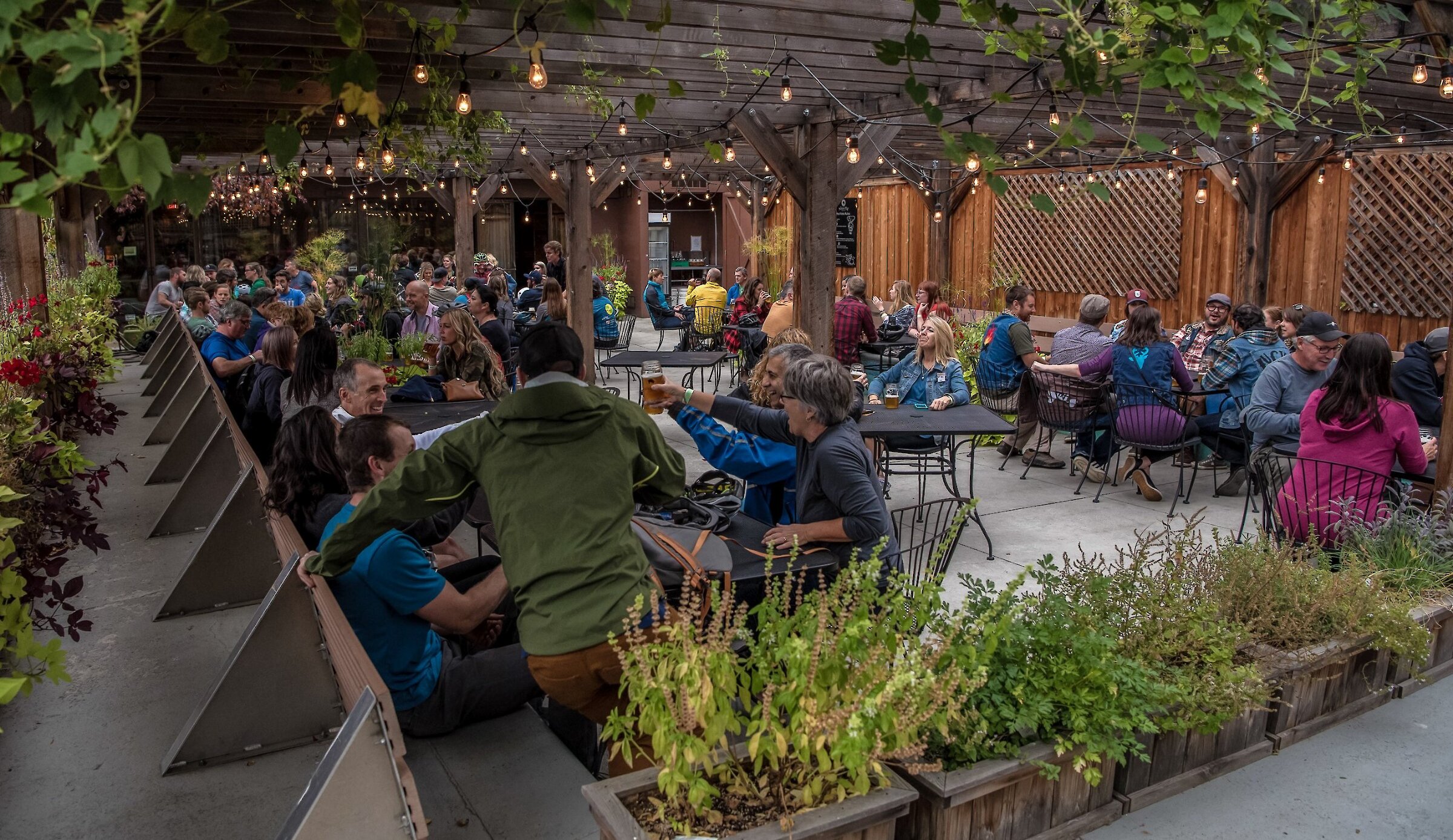 Guests enjoying food and drinks on the patio at Noble Pig Brewhouse, Kamloops’ first microbrewery.