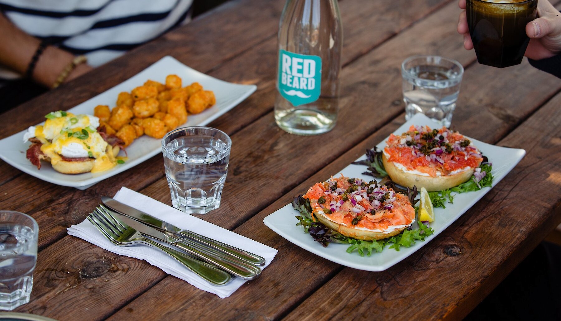 Delicious Brunch plates of Eggs Benedict and a Smoked Salmon Bagel at Red Beard Cafe in Kamloops British Columbia.