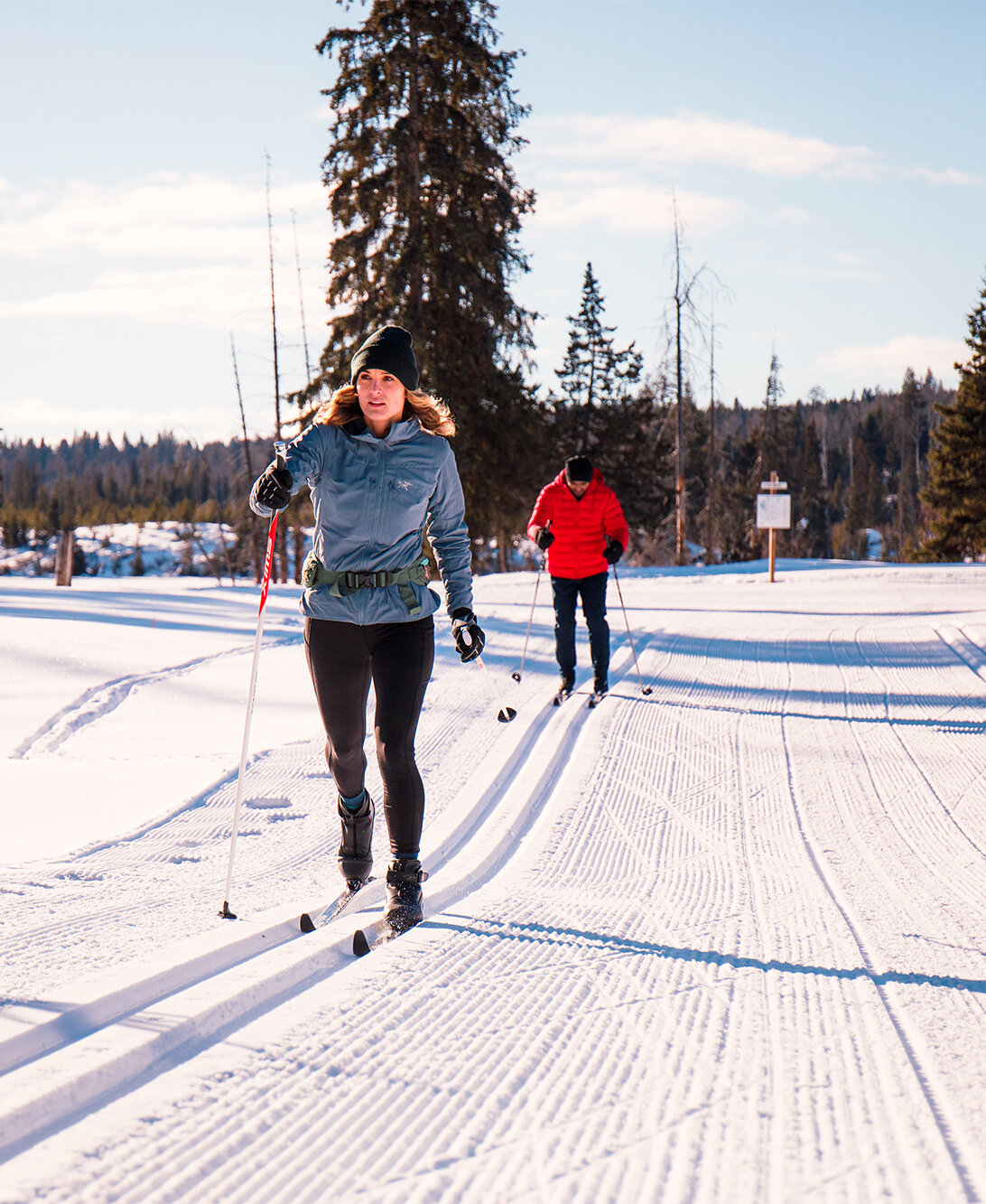 Cross country skiers gliding along the groomed trails at Stake Lake with Overlander Ski Club near Kamloops, BC.
